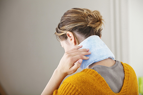 woman with ice pack on neck